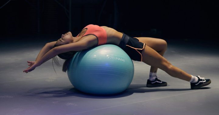 woman doing yoga on stability ball