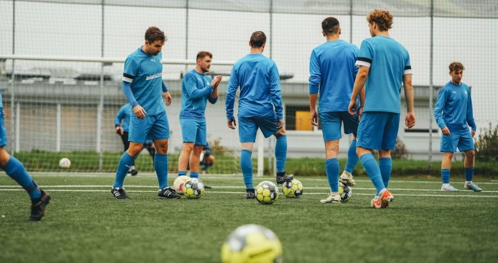 A group of young men playing a game of soccer